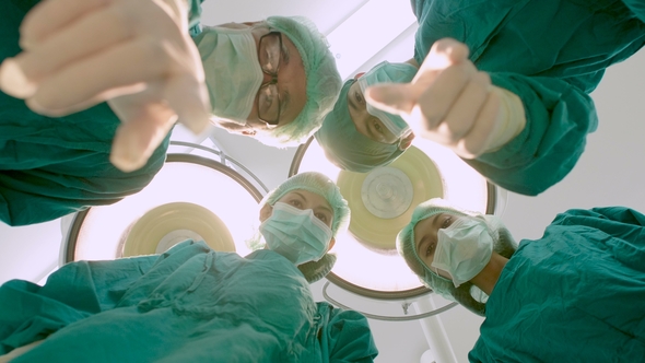 Doctors Looking at the Patient in Operating Theater