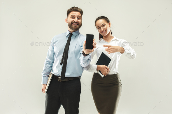 a business man shows the laptop to his colleague in the office. Stock Photo by master1305