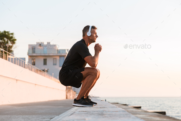 Photo of healthy caucasian man 30s in tracksuit warming up and s - Stock Photo - Images