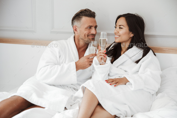 Beautiful couple 30s caucasian man and asian woman wearing white - Stock Photo - Images