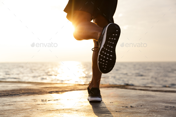Cropped photo of active sporty man legs who wearing tracksuit an - Stock Photo - Images