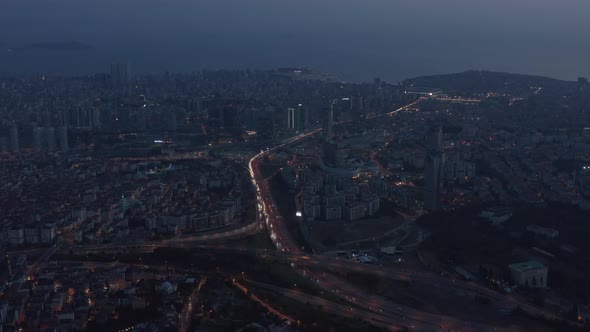 Wide Aerial View Over Istanbul New Financial District at Dusk with Freeway Traffic, Tilt Down alt