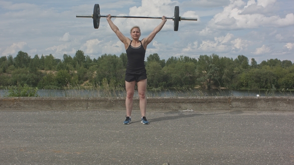 Female Athlete Doing Crossfit Deadlifts Outdoors alt
