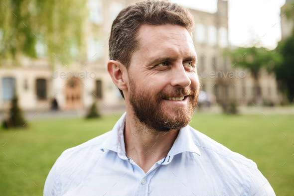 Portrait closeup of handsome man 40s in white shirt, looking asi - Stock Photo - Images
