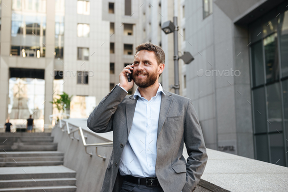 Portrait closeup of smiling joyful business man 40s in gray suit - Stock Photo - Images