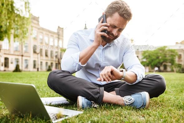 Photo of adult european man in business clothing, looking at sma - Stock Photo - Images