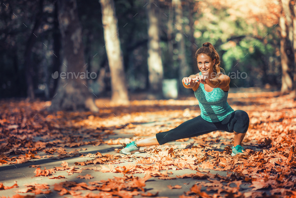 Woman Exercising Outdoors in The Fall Stock Photo by microgen | PhotoDune