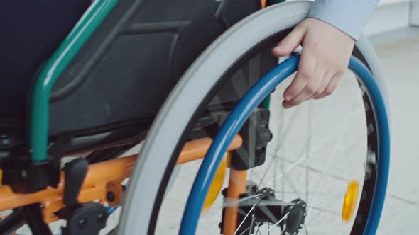 Boy Riding Wheelchair in Closeup alt