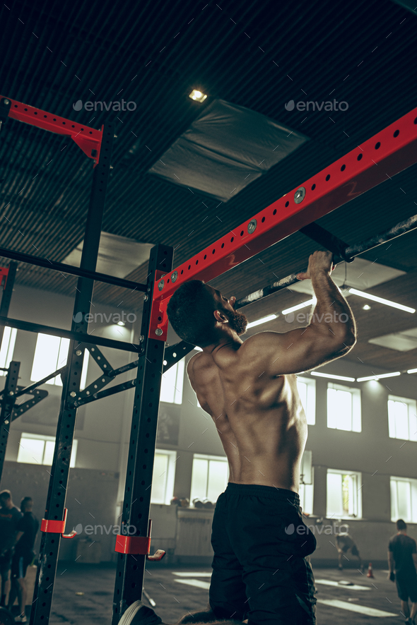 Concept: power, strength, healthy lifestyle, sport. Powerful attractive muscular man at CrossFit gym - Stock Photo - Images