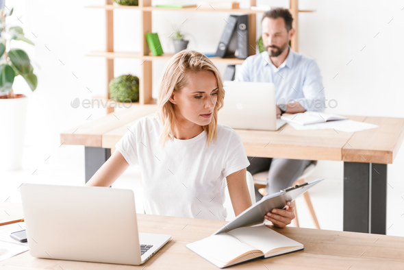 Concentrated woman manager working on laptop computer - Stock Photo - Images