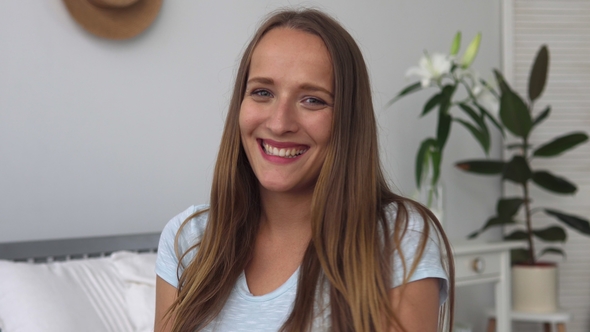 Face of Young Happy Woman with Big Smile in White Room