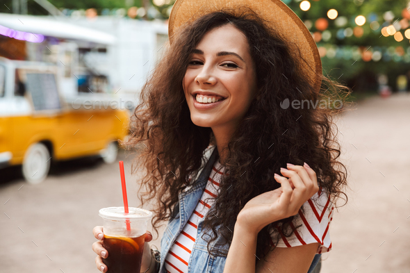 Image of joyful pretty woman 18-20 with curly brown hair wearing - Stock Photo - Images