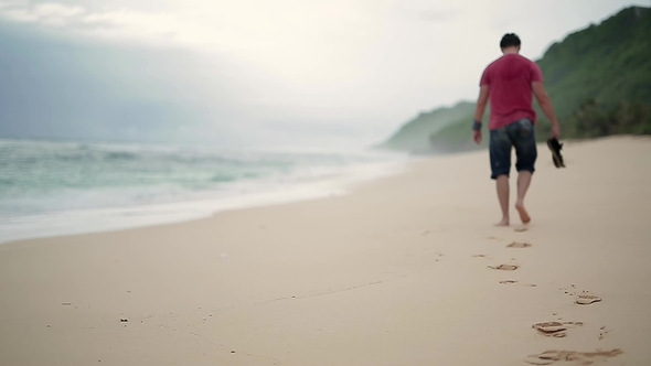 Guy Leaving Footprints on Beach