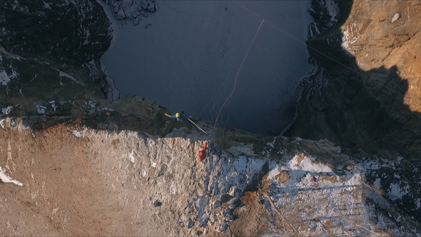 Aerial View of a Man Jumping Off a Cliff. Rope Jumping.