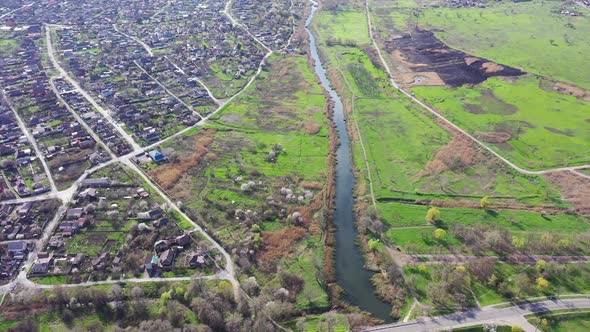Aerial view of the river. A field near the river after a fire.