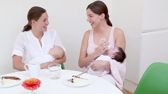 Two mothers with their babies alt