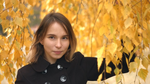 Portrait of Girl in Autumn Park