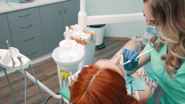 Young Woman at Reception with Dentist