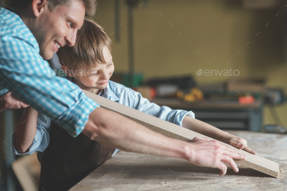 Smiling family in carpentry Stock Photo by AboutImages | PhotoDune