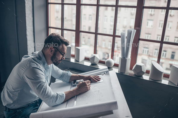 Young man in the workplace Stock Photo by AboutImages | PhotoDune