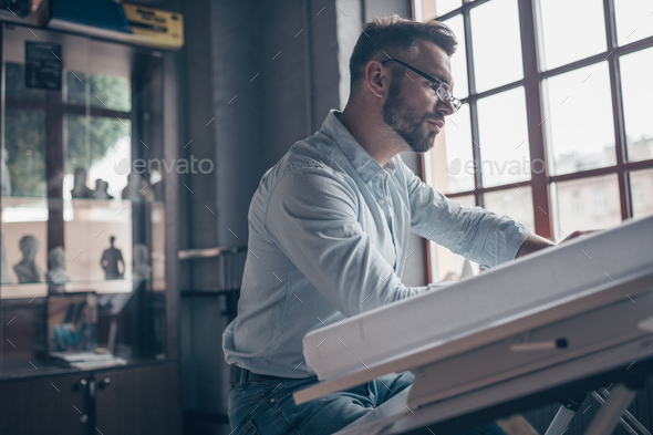 Working engineer with a drawing Stock Photo by AboutImages | PhotoDune
