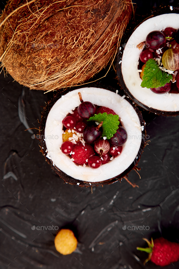 Fruit salad in coconut shell bowl - Stock Photo - Images