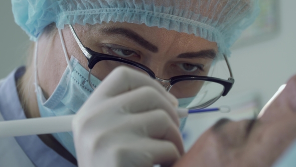 Dermatologist Remove Mole with Laser on the Face of Man alt