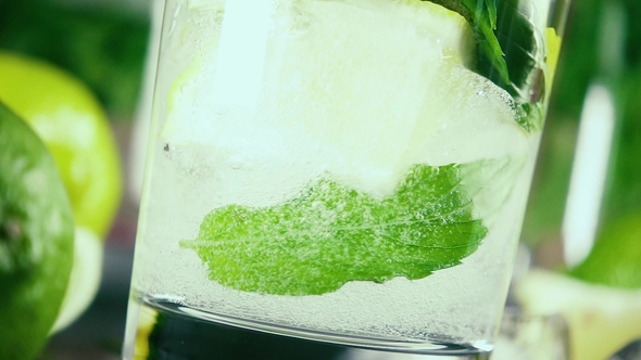 Pour Soda Into a Glass of Ice Mint and Lemon
