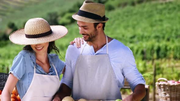 Happy couple standing in farm alt