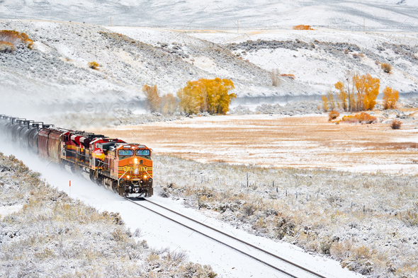 Train transporting tank cars. Season changing autumn to winter. Stock Photo by haveseen