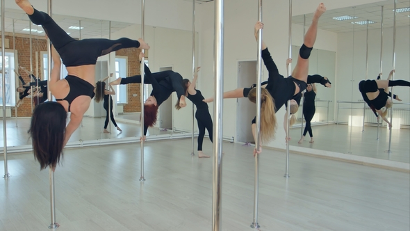Five Sexy Slim Women Team Pole Dance Training in Dance Hall alt