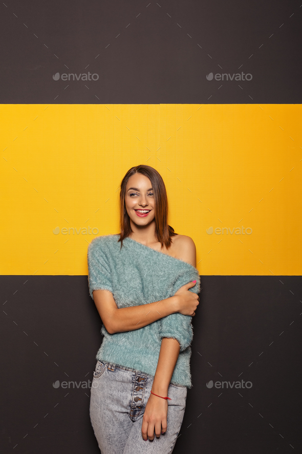 Pretty young lady fooling around in studio - Stock Photo - Images