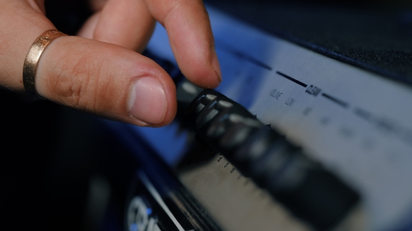 Hands Twist Tumblers on Control Panel of Guitar Amplifier. A Mode Switch Being Switches on Amp. Man alt