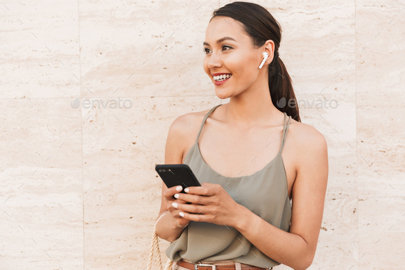 Portrait of smiling brunette woman wearing casual summer clothin - Stock Photo - Images