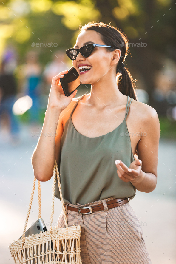 Image of beautiful brunette woman wearing casual summer outfit a Stock  Photo by vadymvdrobot