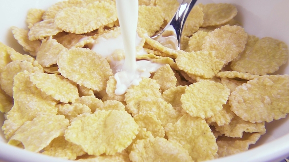 Pouring Milk into a Bowl of Flakes