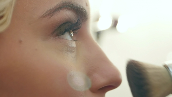 Applying Cosmetic Powder with a Big Brush on Face alt