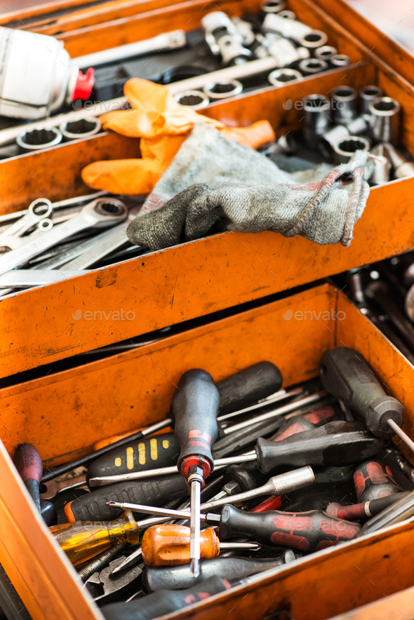 Open orange metal tool box with assorted tools Stock Photo by Photology75