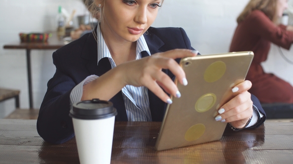 Young Woman Is Concentrated on Her Work in Cafe