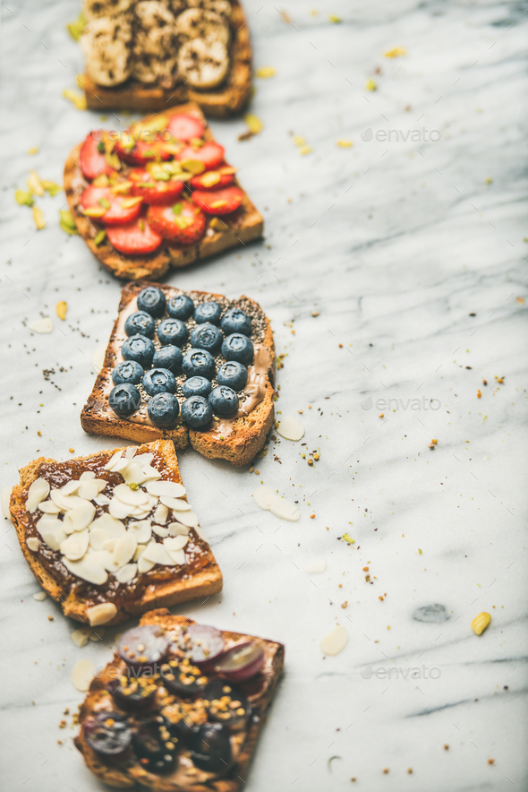 Vegan whole grain toasts with fruit, seeds, nuts - Stock Photo - Images