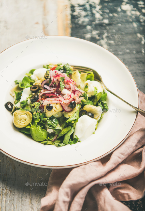 Fresh green summer salad over wooden painted background, selective focus - Stock Photo - Images