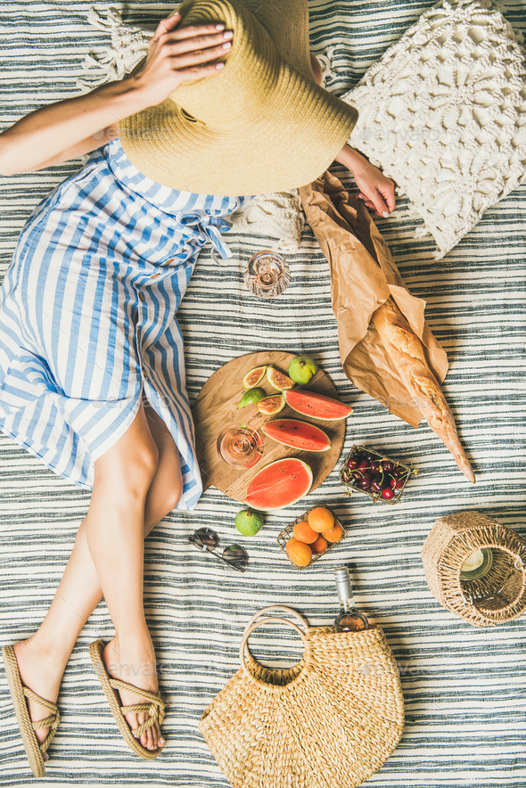 Woman in hat and dress with wine, fruits and baguette - Stock Photo - Images