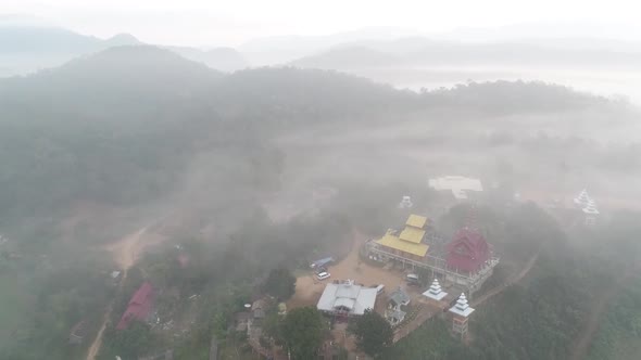 Aerial Footage Of Wat Su Tong Pae, Famous Temple In Mae Hong Son, Thailand in Foggy Weather alt