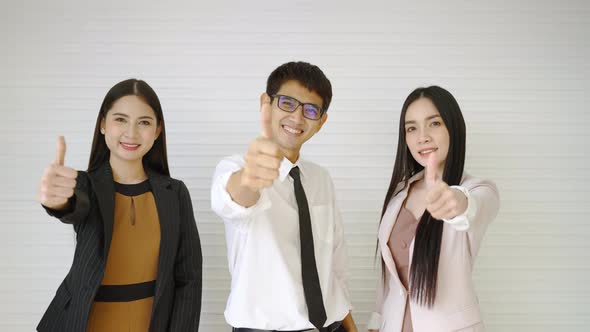 Company employees thumb up with confidence. stable business concept