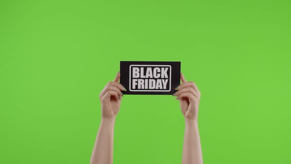 Black Friday Advertisement Inscription on Paper Sheet in Womans Hands on Chroma Key. Slow Motion alt