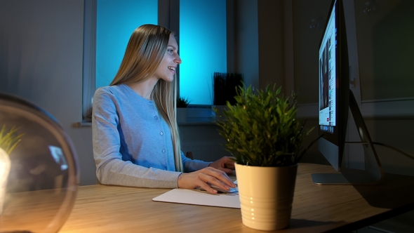 Smiling Woman Working on Computer at Night Smiling Female alt
