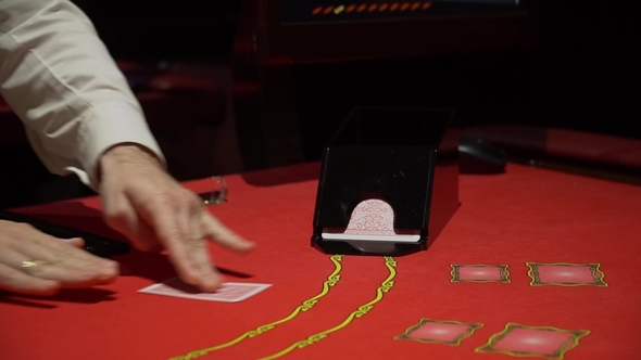 Cards Being Dealt at Poker Game in Casino