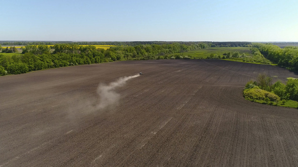 Aerial View of Agricultural Tractor Cultivating Field. Tractor At Work