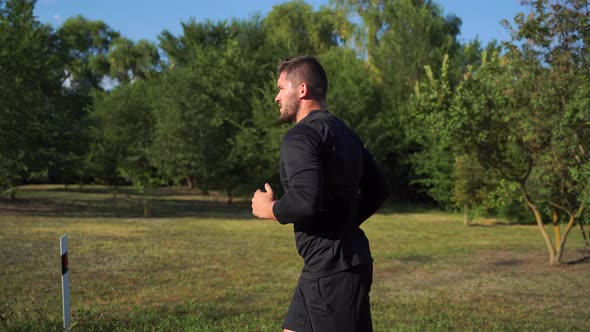 Tracking Shot of Sportsman Jog Cardio WorkoutTrainer Fitness Hard Training Before Running Marathon alt