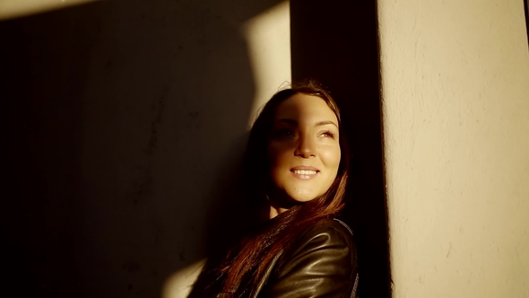 Portrait of a Cute and Young Woman Looking at the Sun From the Penumbra alt